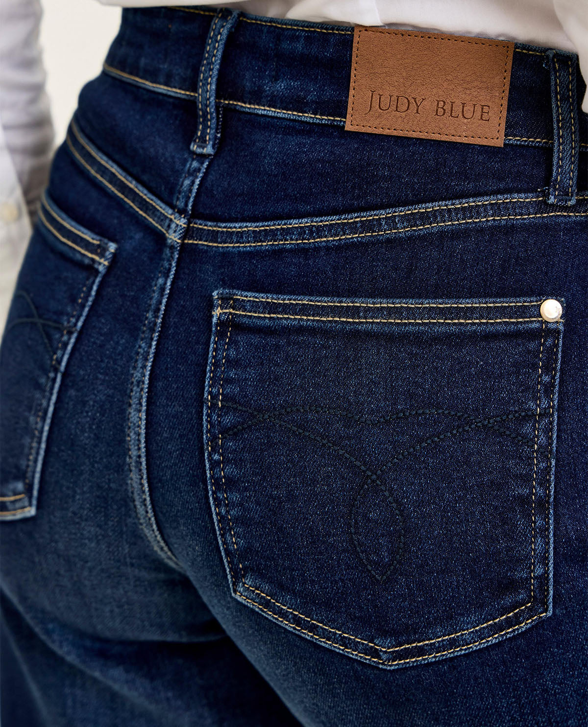 Close-up of blue jeans with a Judy Blue label on the waistband.