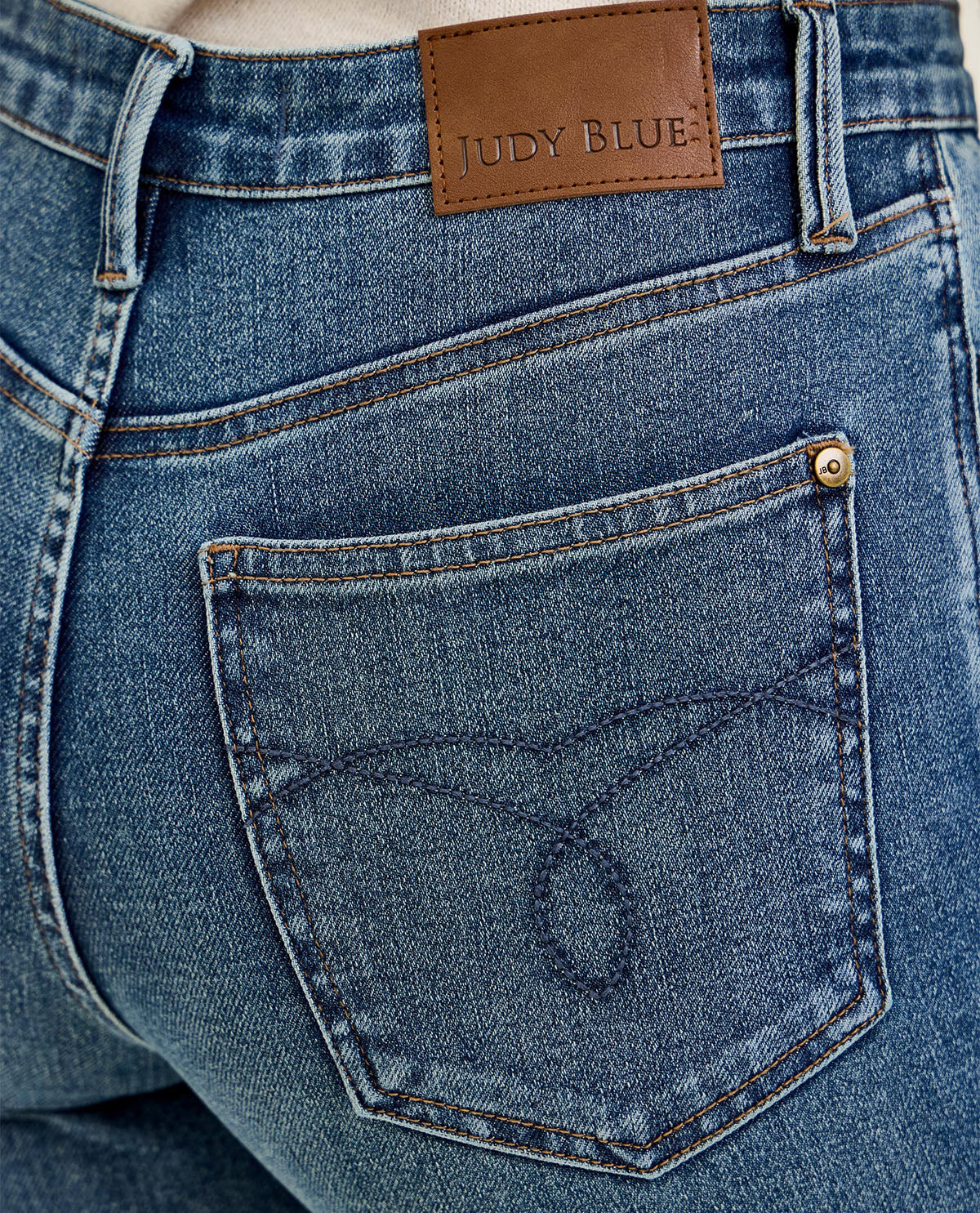 Close-up of blue jeans with a Judy Blue label on the back pocket.