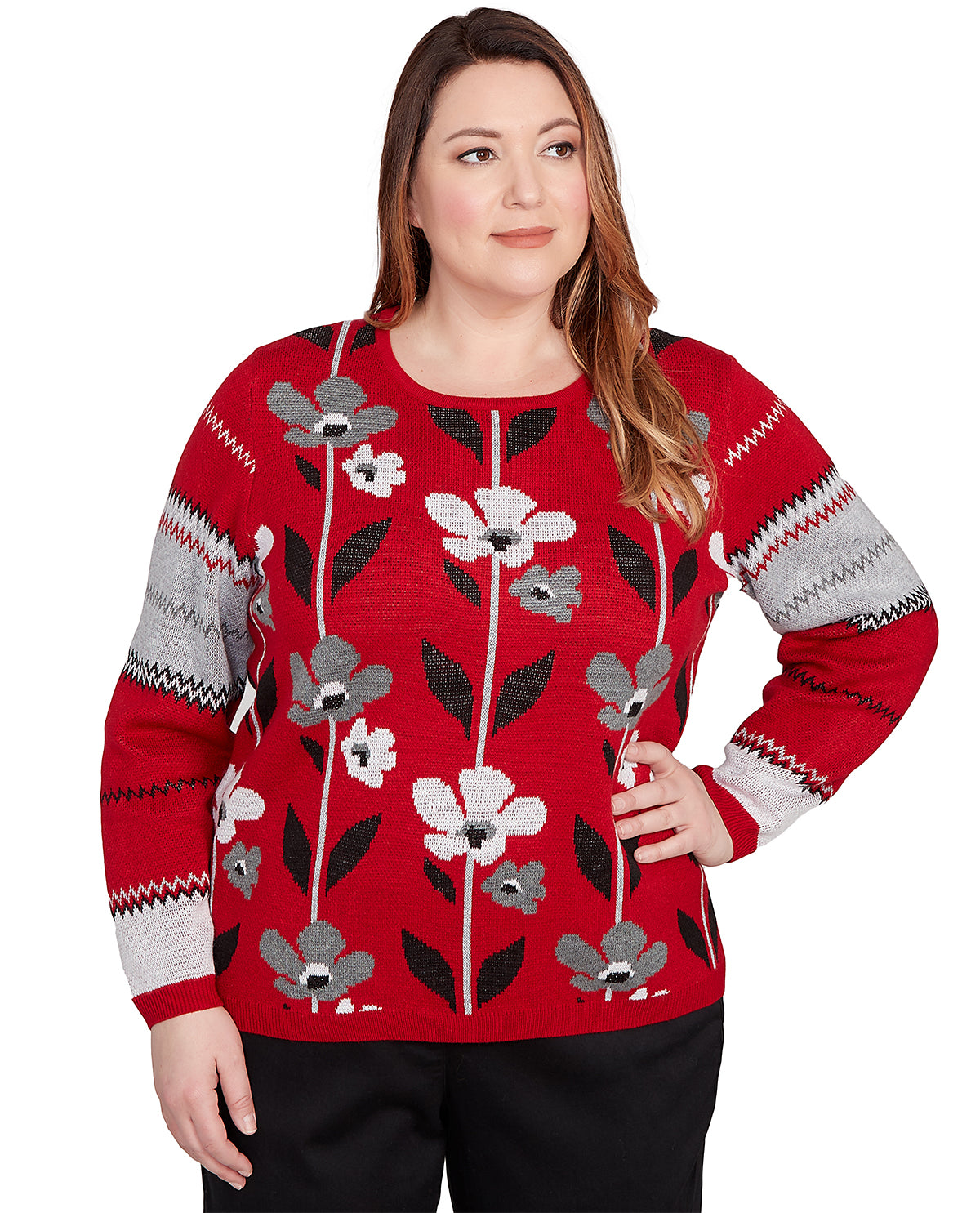 Woman wearing a red sweater with floral patterns on a white background