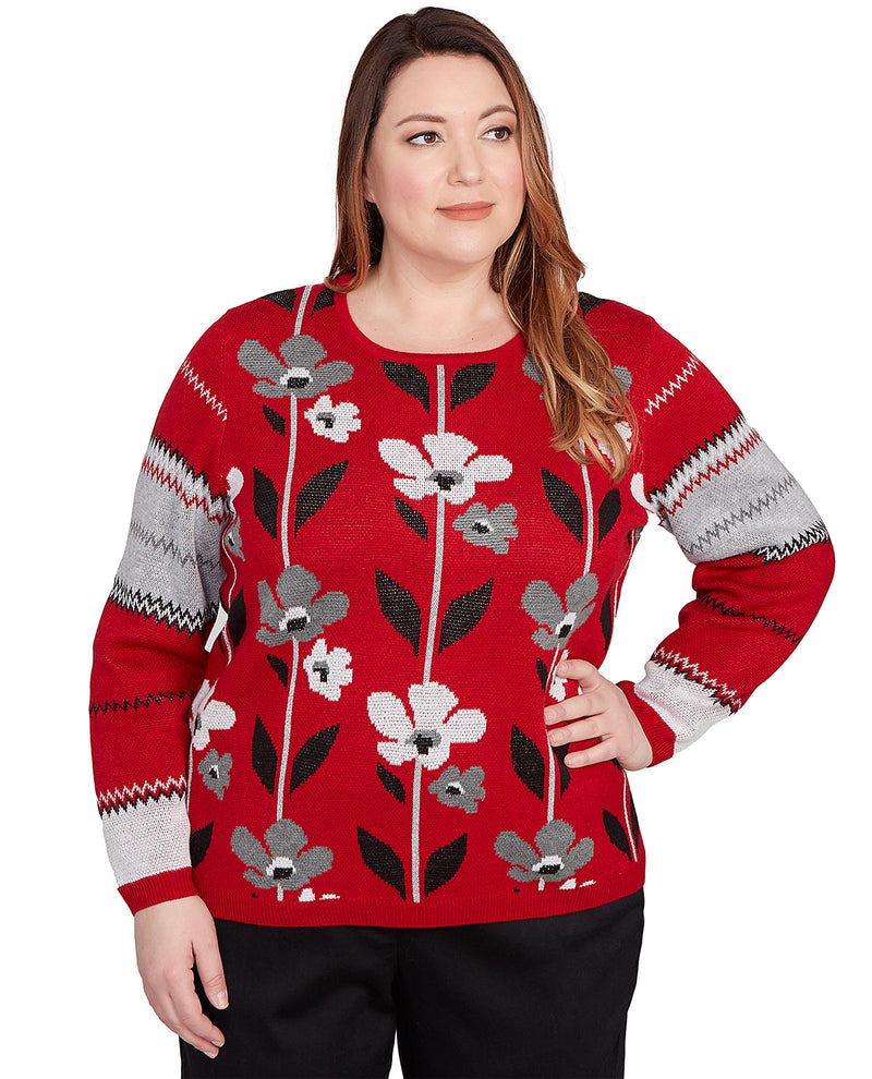 Woman wearing a red sweater with floral patterns on a white background