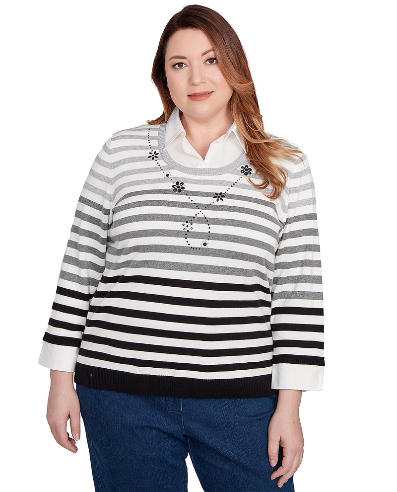 Woman wearing a black and white striped sweater on a white background
