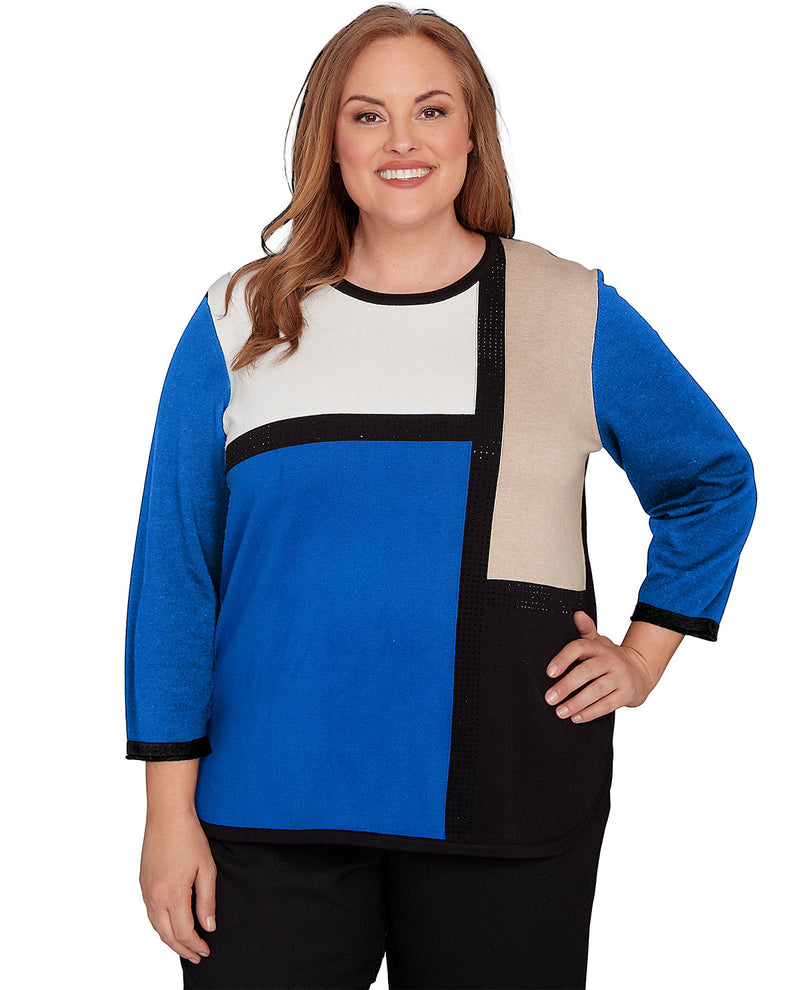 Woman wearing a colorful sweater with a white background