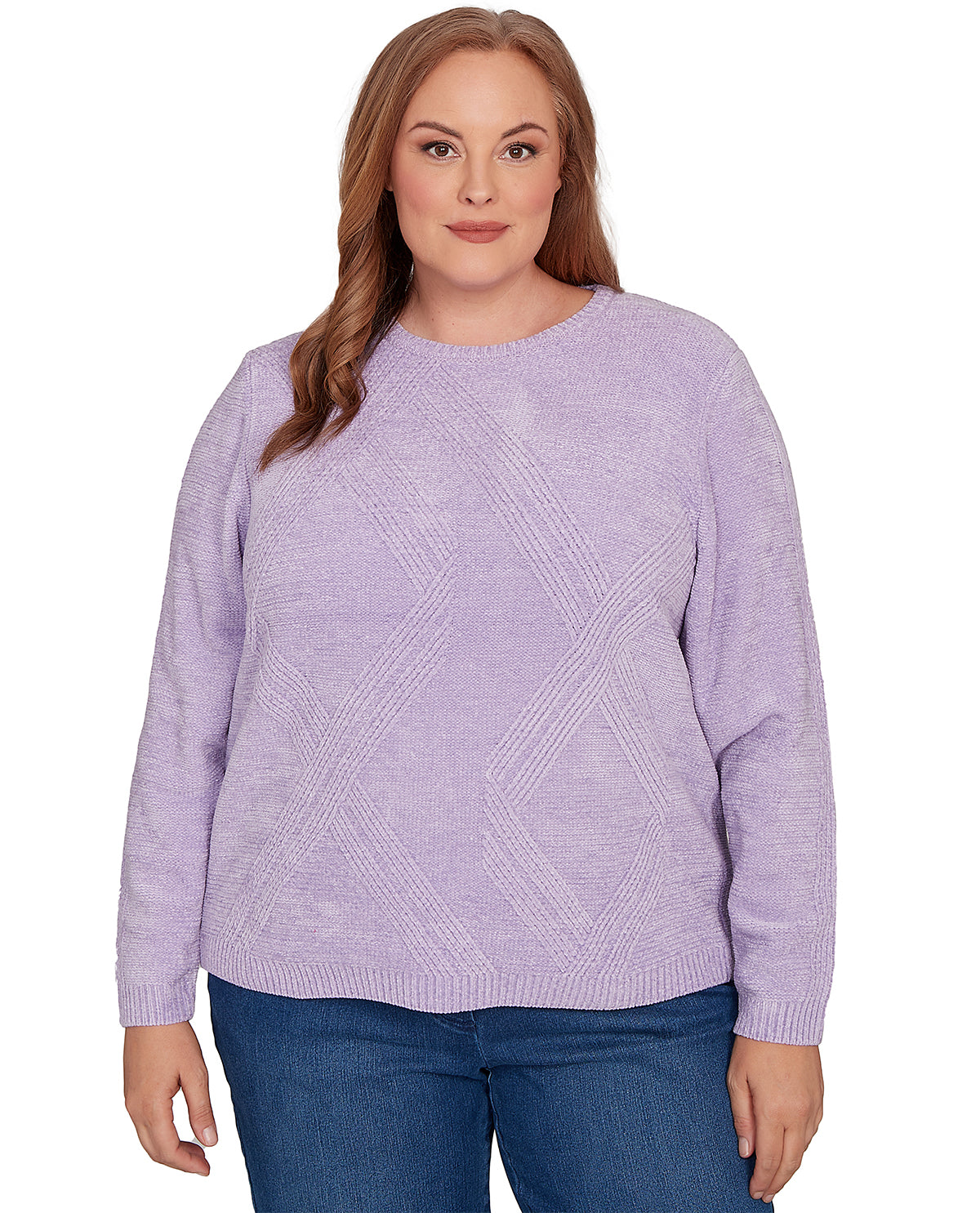 A woman wearing a light purple knit sweater with a textured geometric diamond pattern and blue jeans, shown against a plain white background.