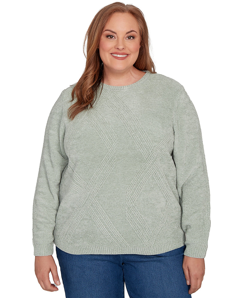 Woman wearing a light green sweater on a white background