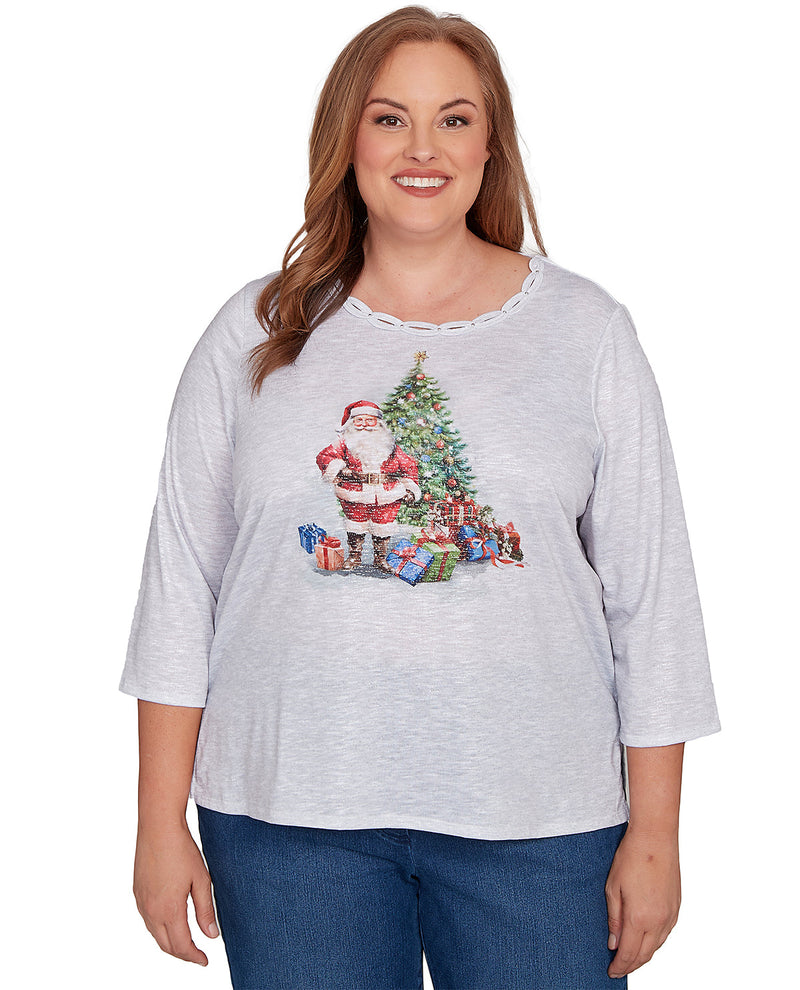 Woman wearing a gray Christmas-themed shirt with a Santa Claus and tree design on a white background