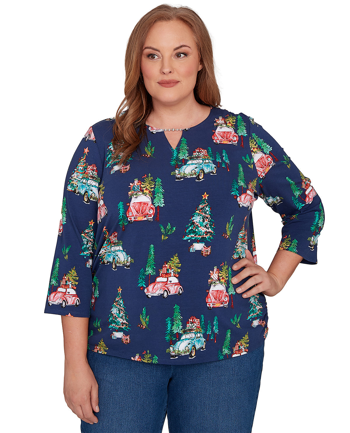 Woman wearing a blue festive patterned top on a white background