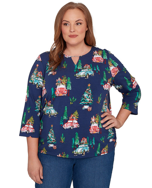 Woman wearing a blue festive patterned top on a white background