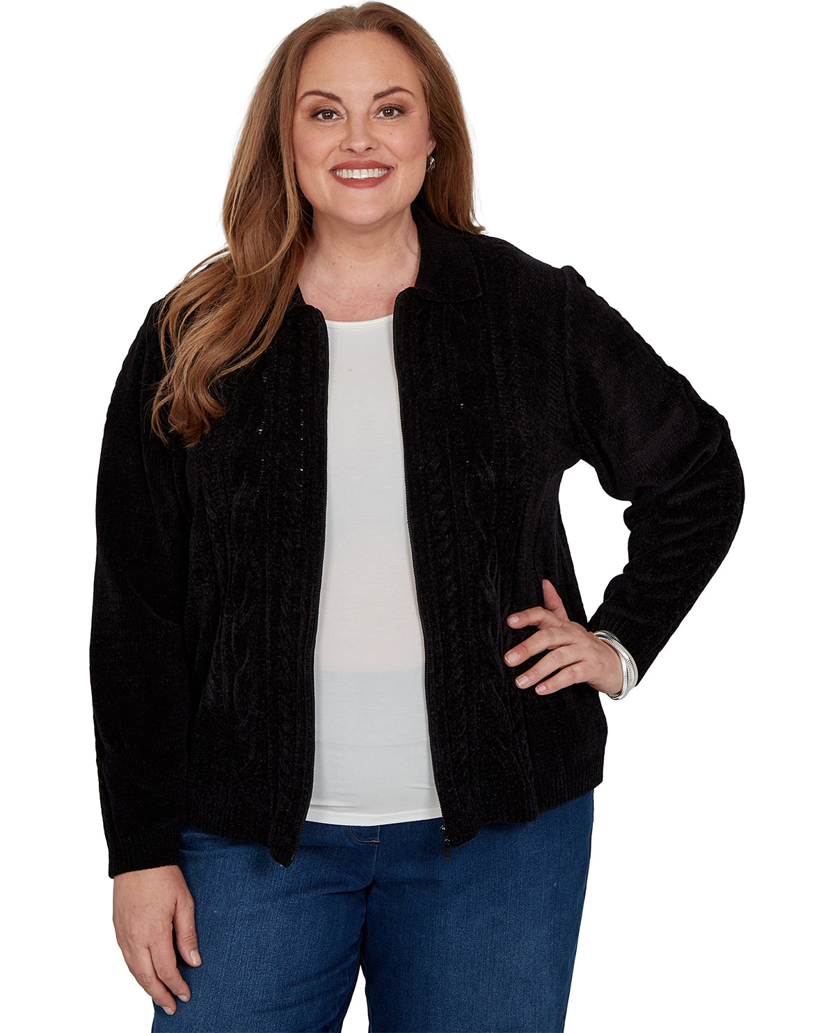 A woman modeling a black textured zip-up jacket over a white top and blue jeans, photographed against a plain white studio background.