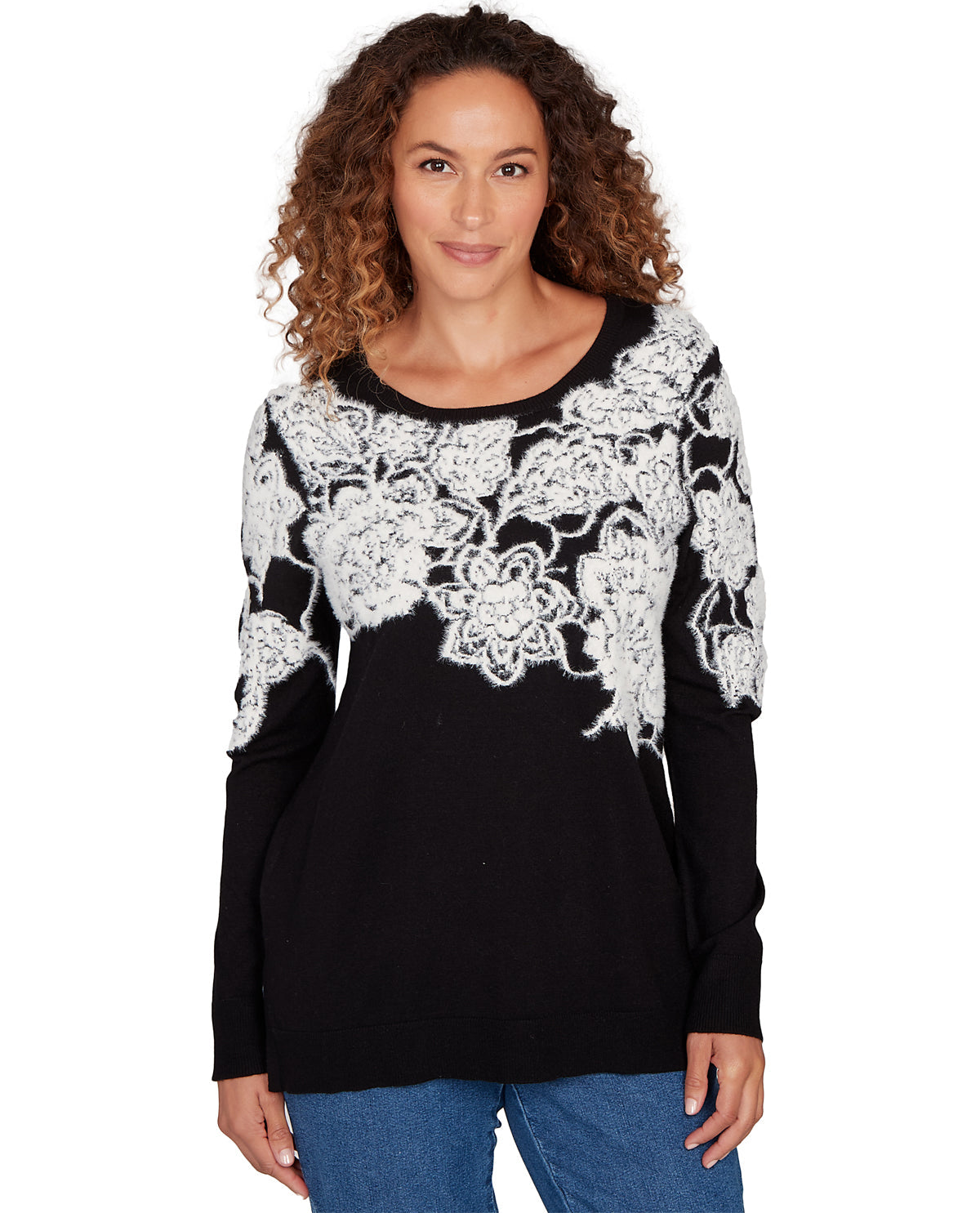 Woman wearing a black sweater with white lace detailing on a white background
