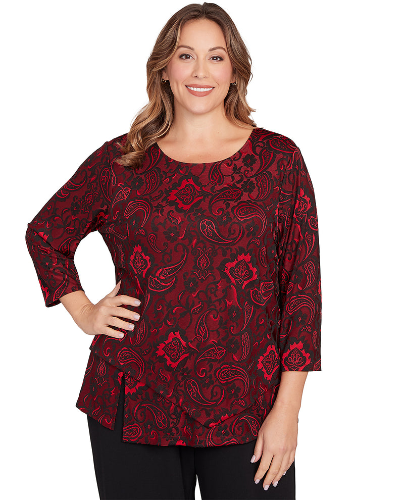 Woman wearing a red patterned top on a white background