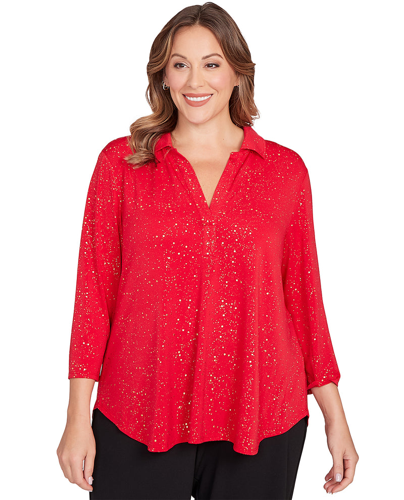 Woman wearing a 3/4 sleeve red blouse with a white background