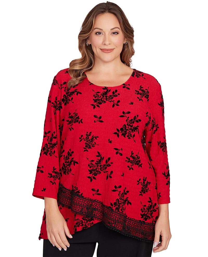 Woman wearing a red floral-patterned top on a white background