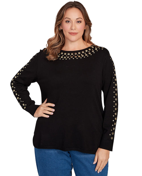 Woman wearing a black long-sleeve top with decorative elements on a white background