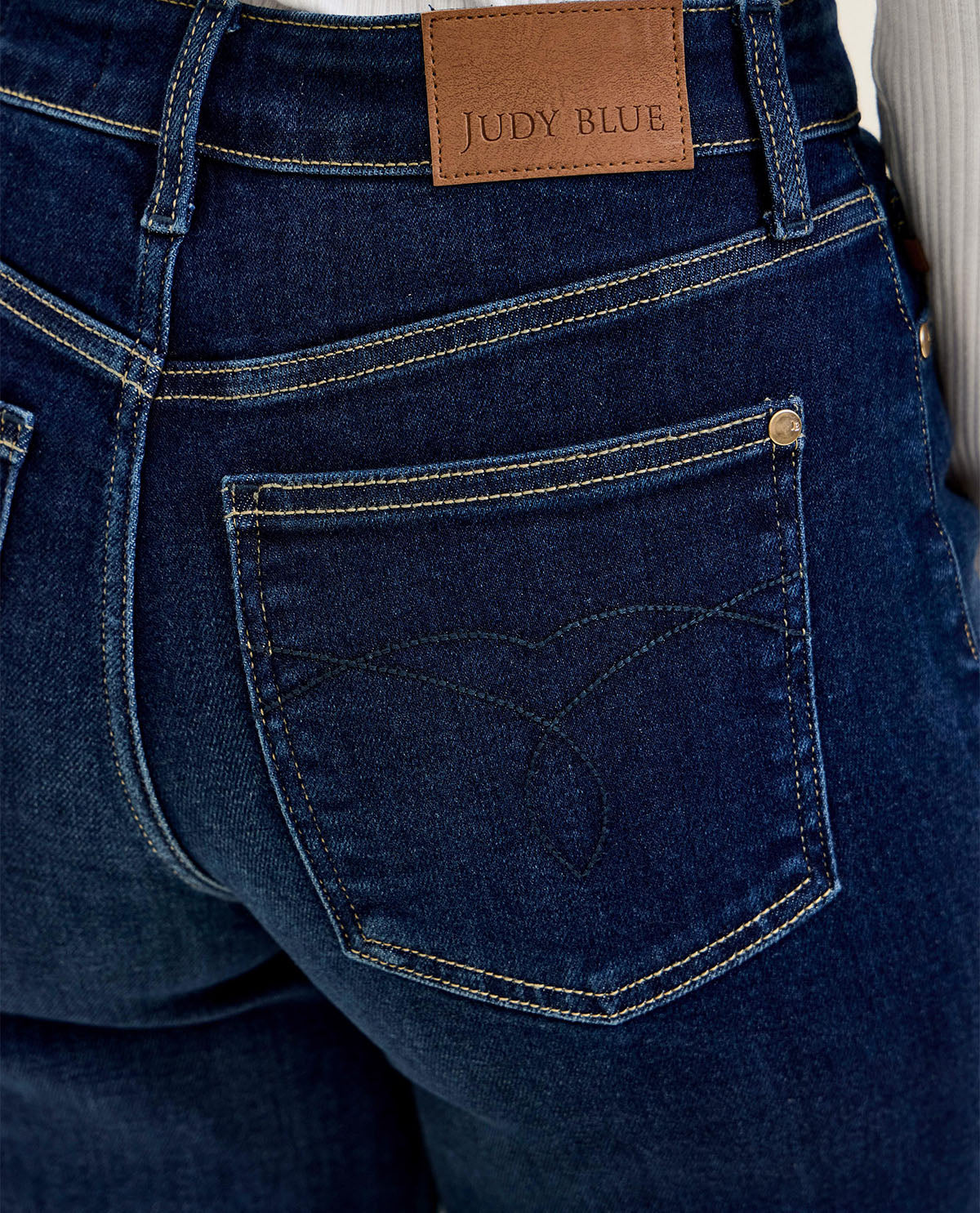 Close-up of blue jeans with a Judy Blue label on the pocket.