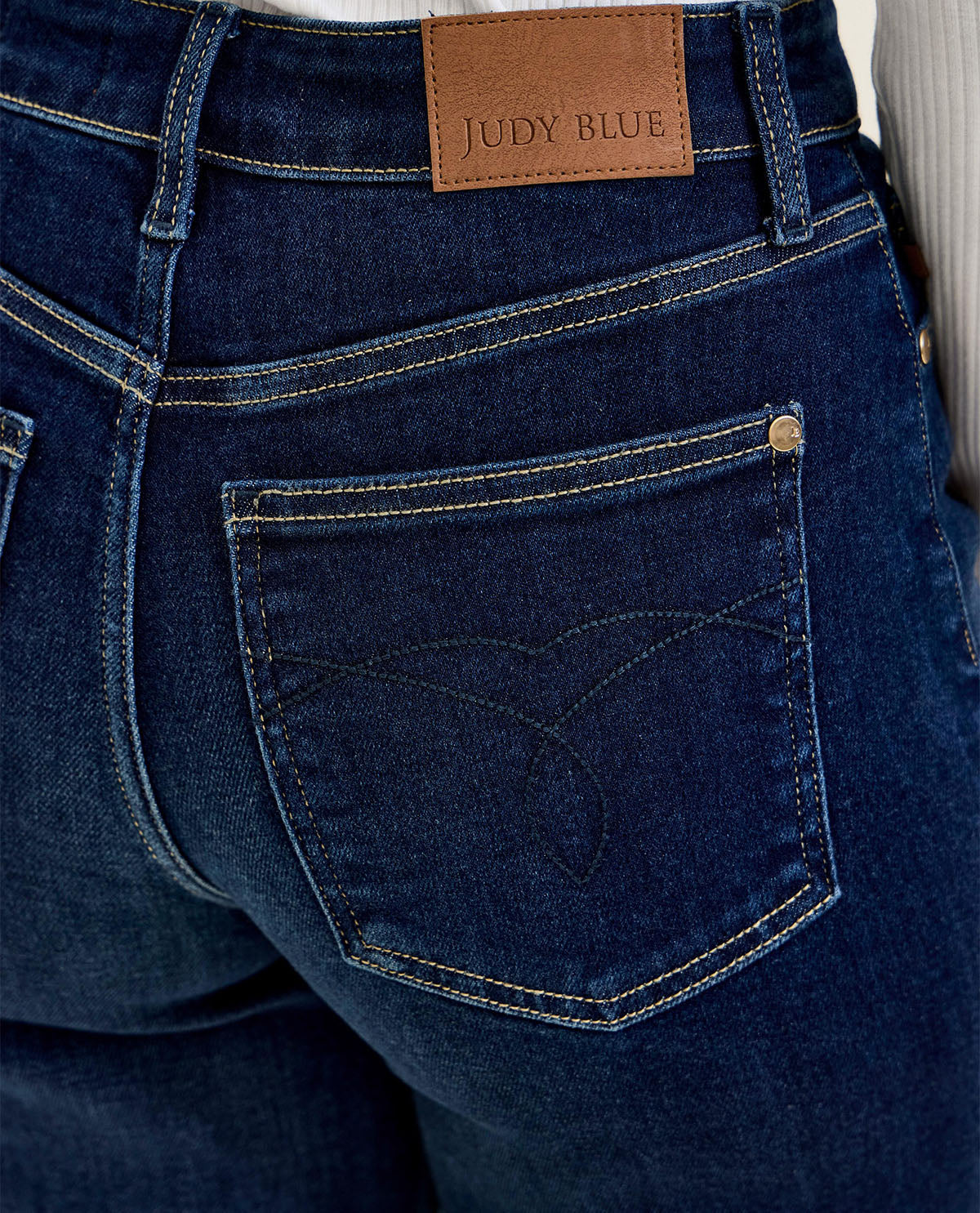Close-up of blue jeans with a Judy Blue label on the back pocket.