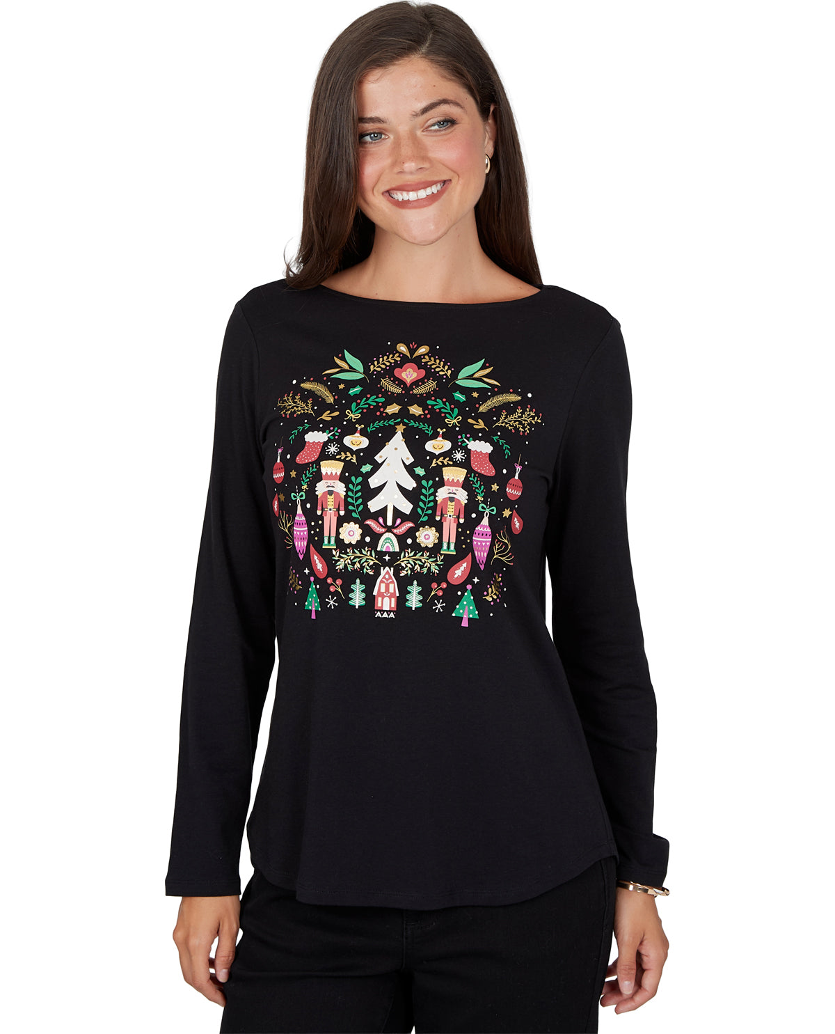 A woman wearing a black long-sleeve boatneck top with a colorful Christmas nutcracker graphic on the front, set against a plain white background.