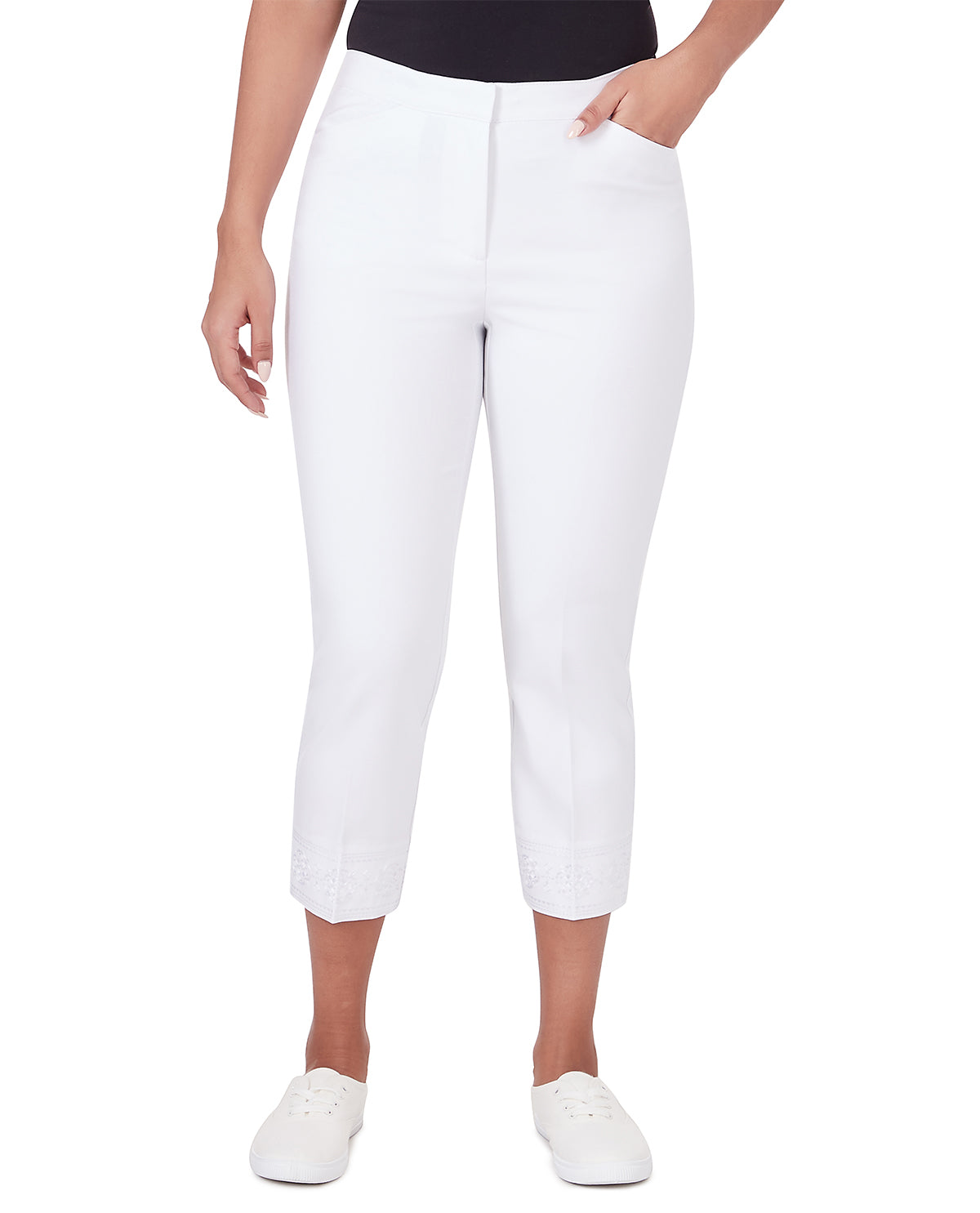 White cropped capri pants shown on a model from the waist down, paired with a black top and white slip-on shoes against a plain white background.