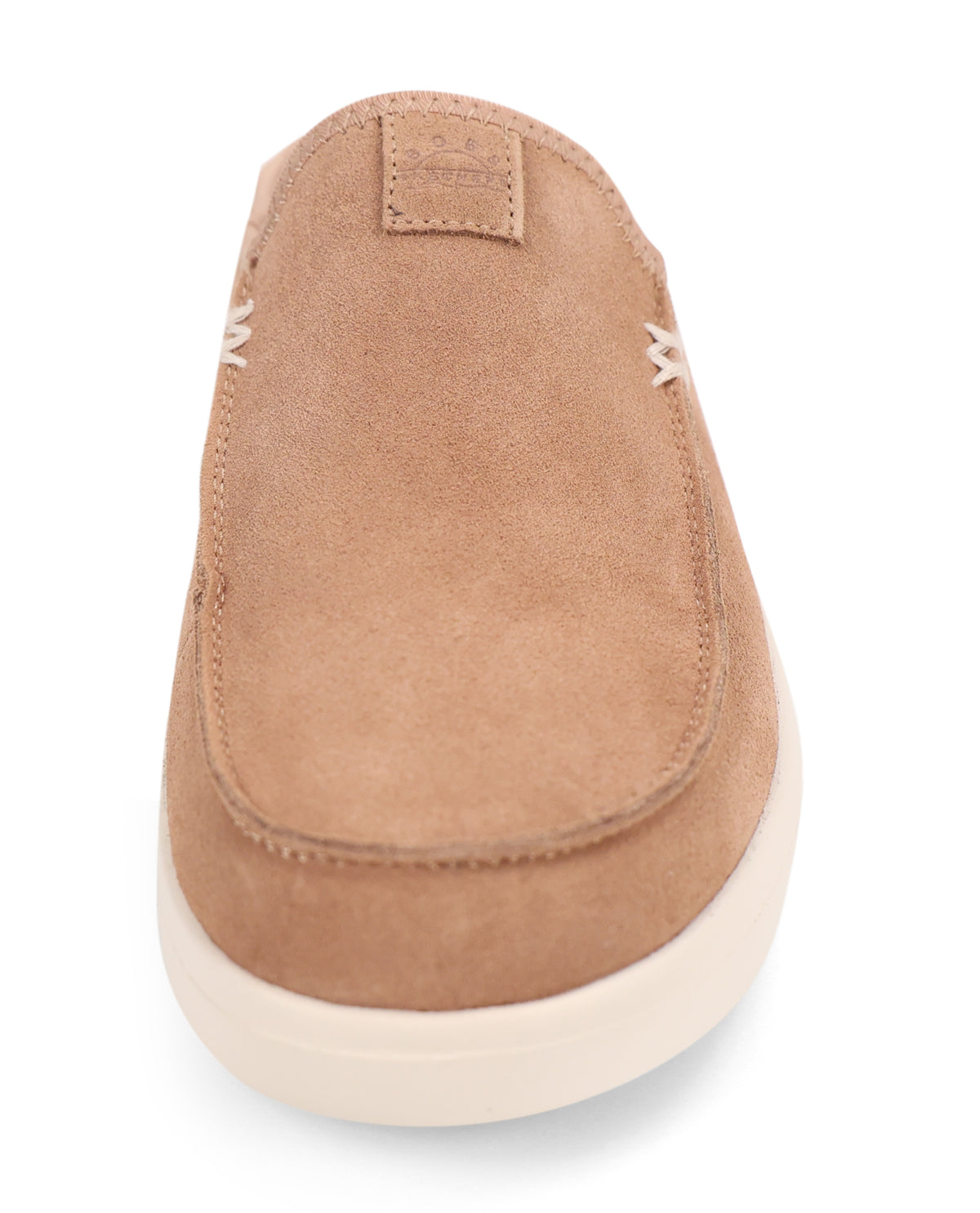 A tan suede slip-on shoe with white stitching details and a thick off-white sole, shown from a top-down view on a white background.
