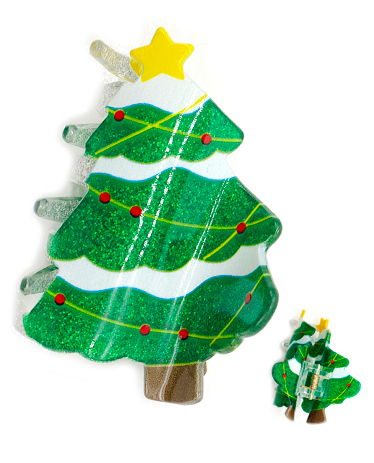 A Christmas tree-shaped clear glass candle with a green glitter body, white bands, yellow star and line details, red ornaments, and a brown base, shown on a white background with a smaller inset of the same design.