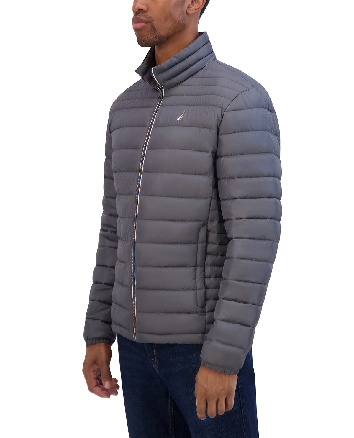 Man wearing a gray quilted jacket with a brand logo on a white background