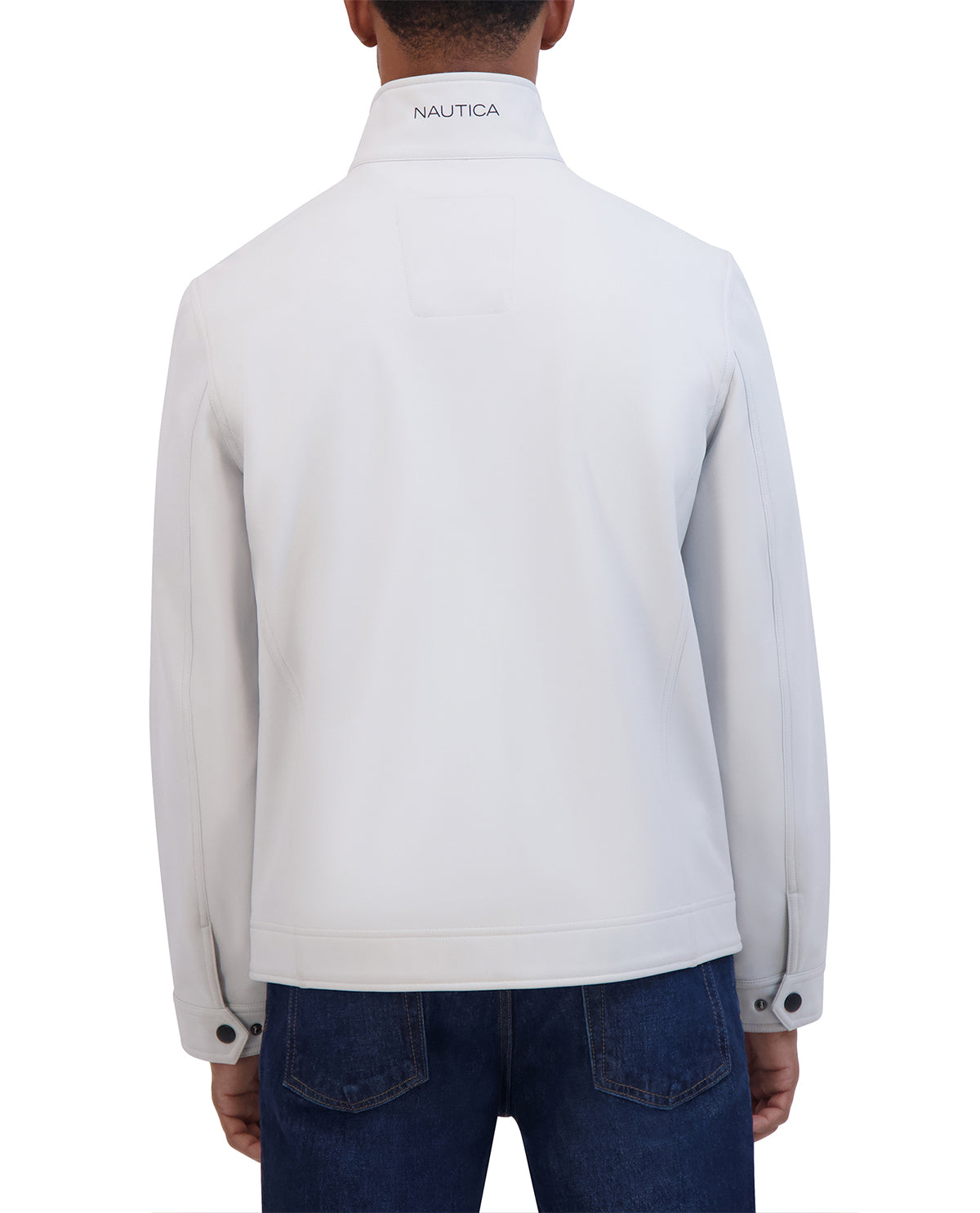 Person wearing a light gray Nautica jacket on a white background