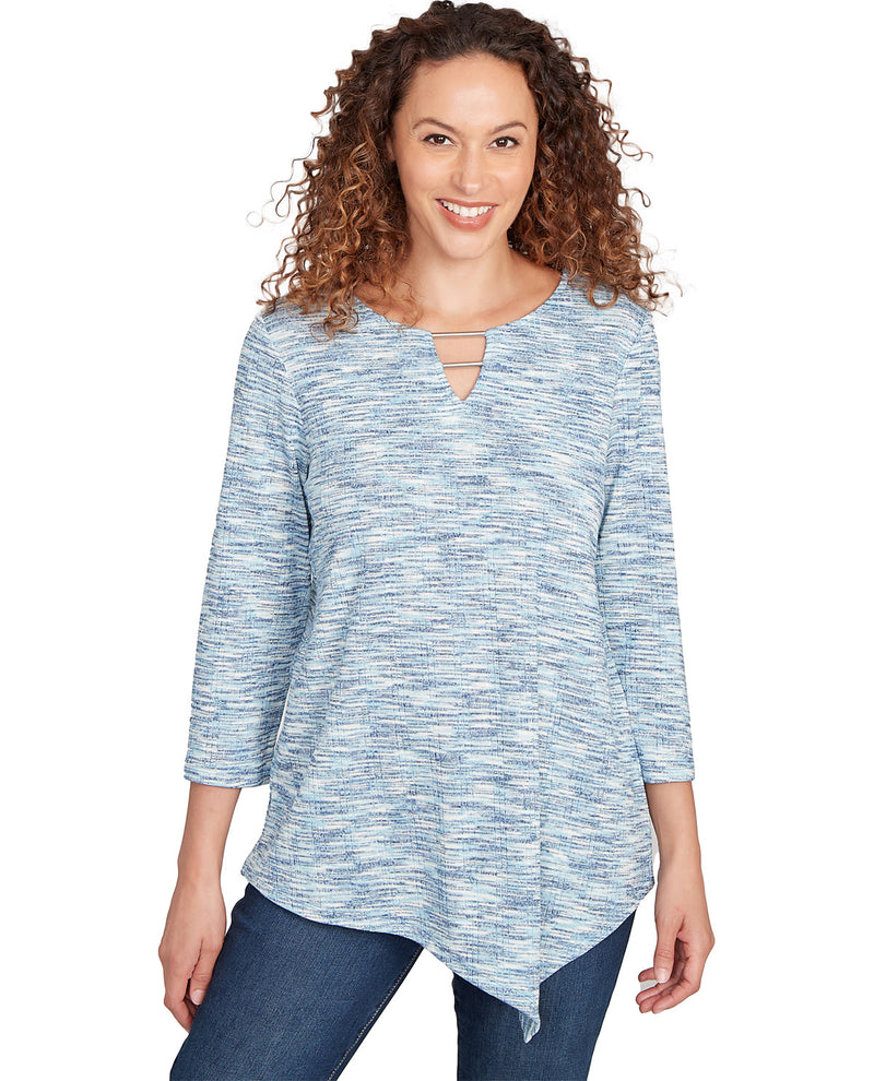 Woman wearing a blue patterned top on a white background