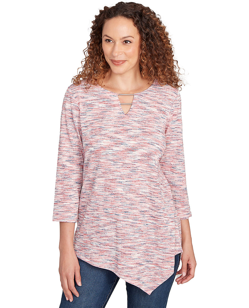 Woman wearing a patterned long-sleeve top on a white background