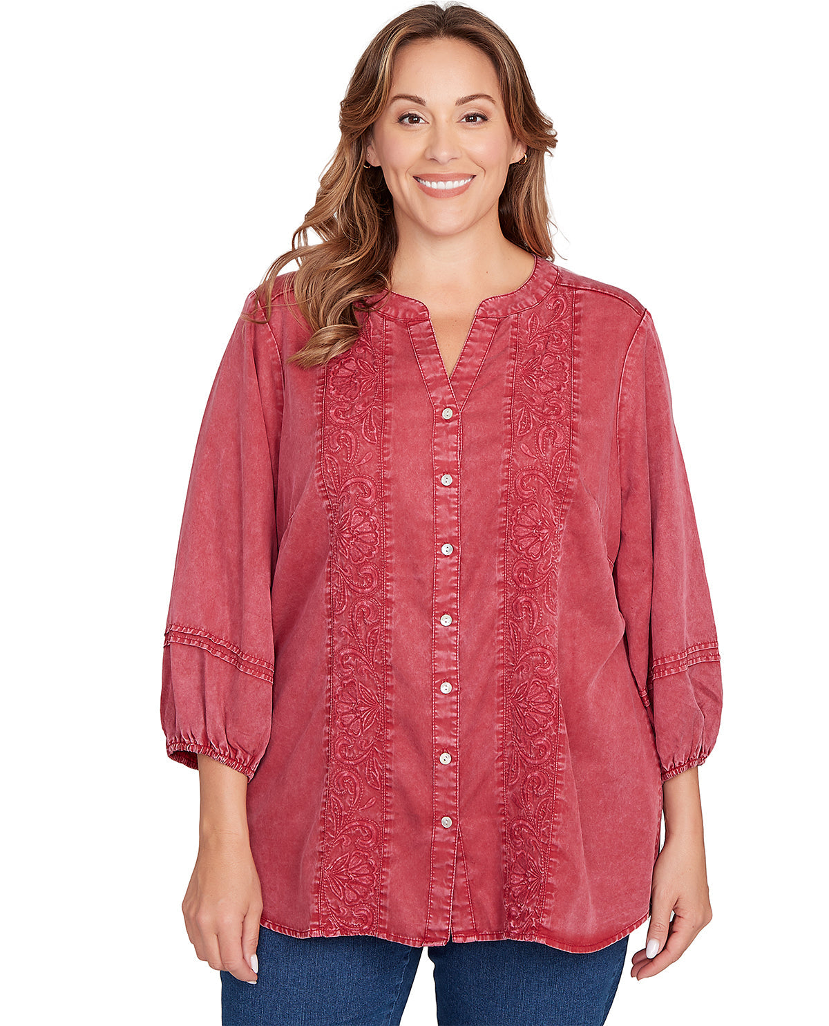 Woman wearing a red blouse with lace details on a white background