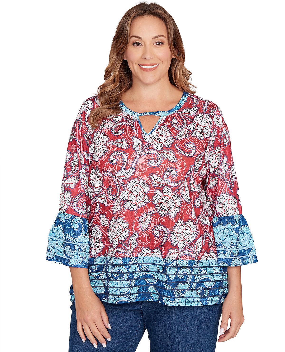 Woman wearing a colorful floral blouse with blue accents on a white background