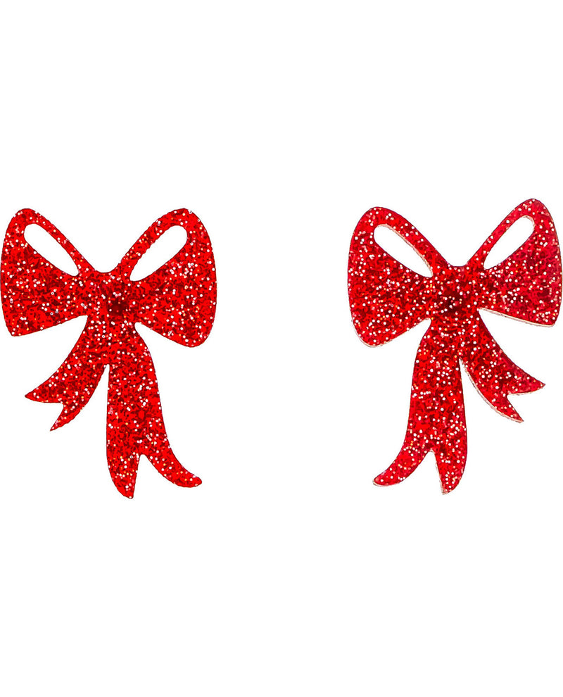 A pair of red glitter bow-shaped earrings on a plain white background.