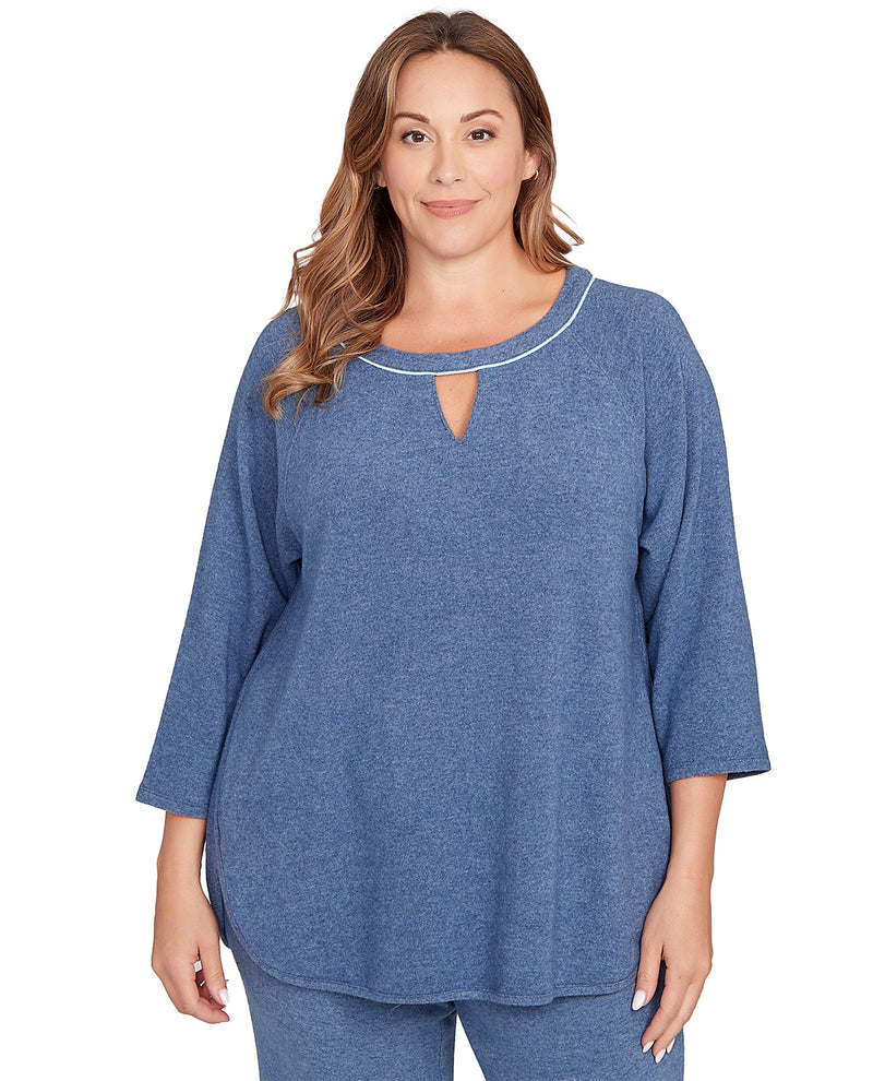 Woman wearing a blue top with a cut-out design on a white background