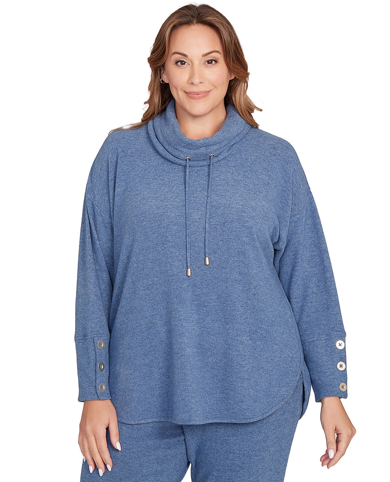 Woman wearing a blue cowl-neck top with button details on a white background