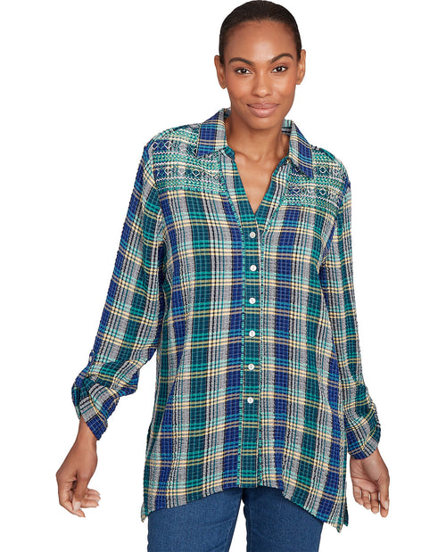 Woman wearing a plaid shirt with a white background