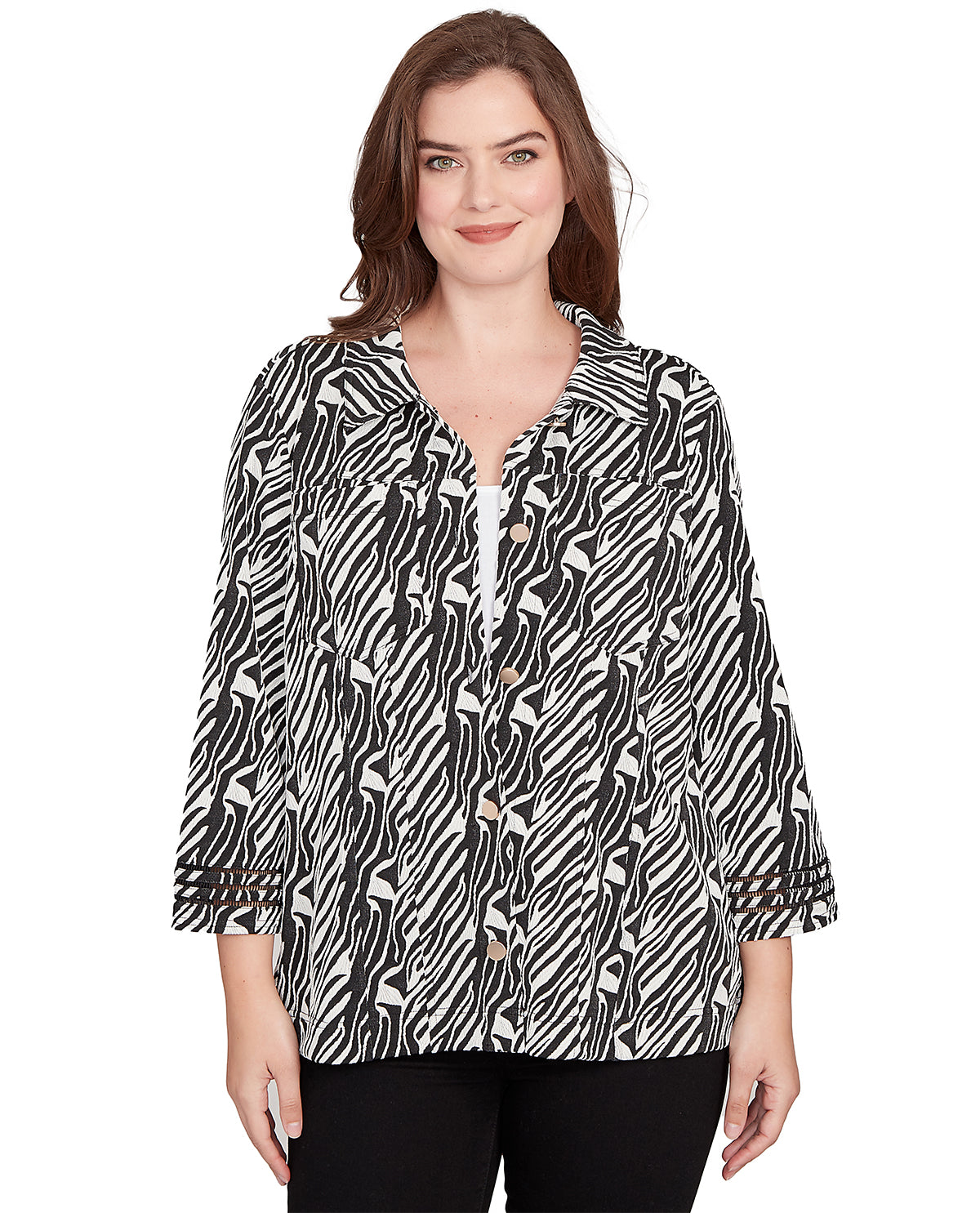 Woman wearing a black and white patterned blouse on a white background