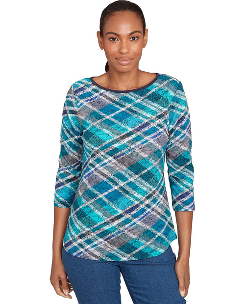 Woman wearing a blue plaid sweater on a white background