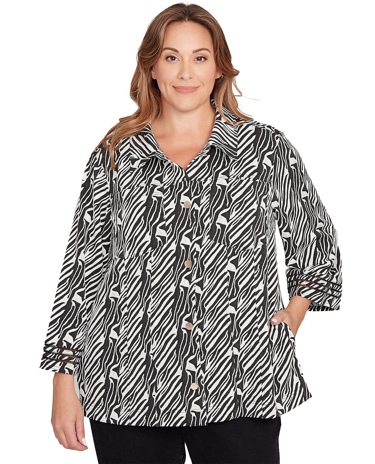 Woman wearing a black and white patterned blouse on a white background