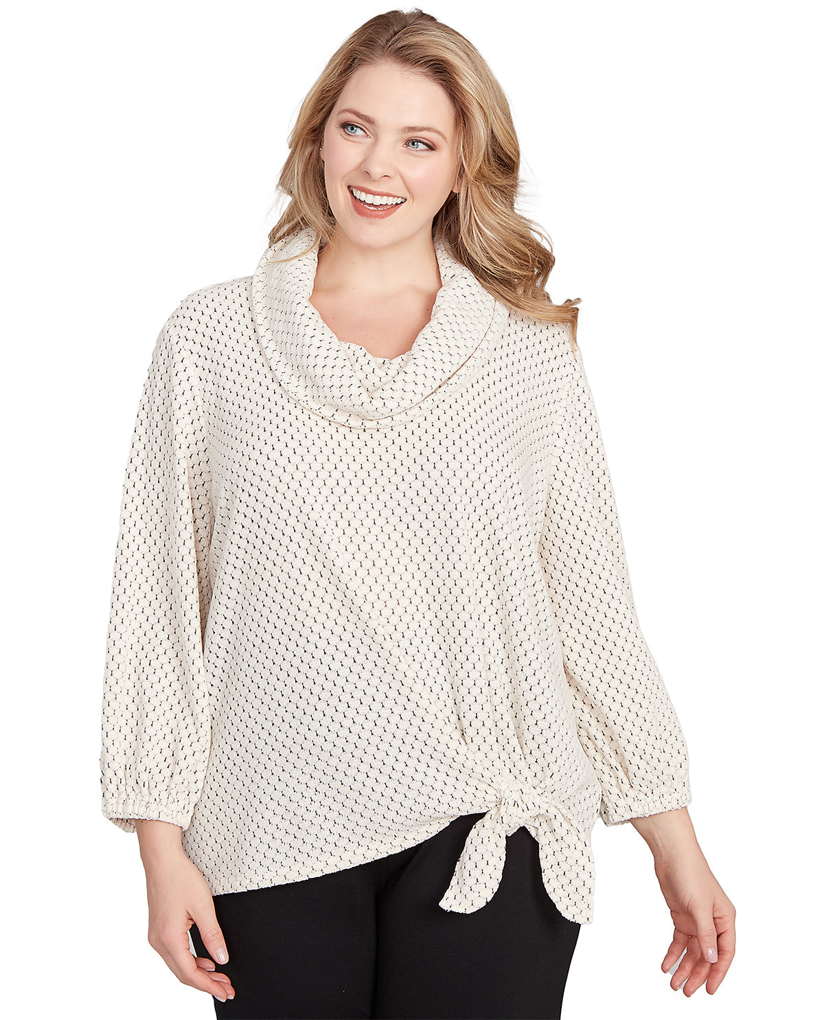 Woman wearing a cream-colored knitted poncho on a white background