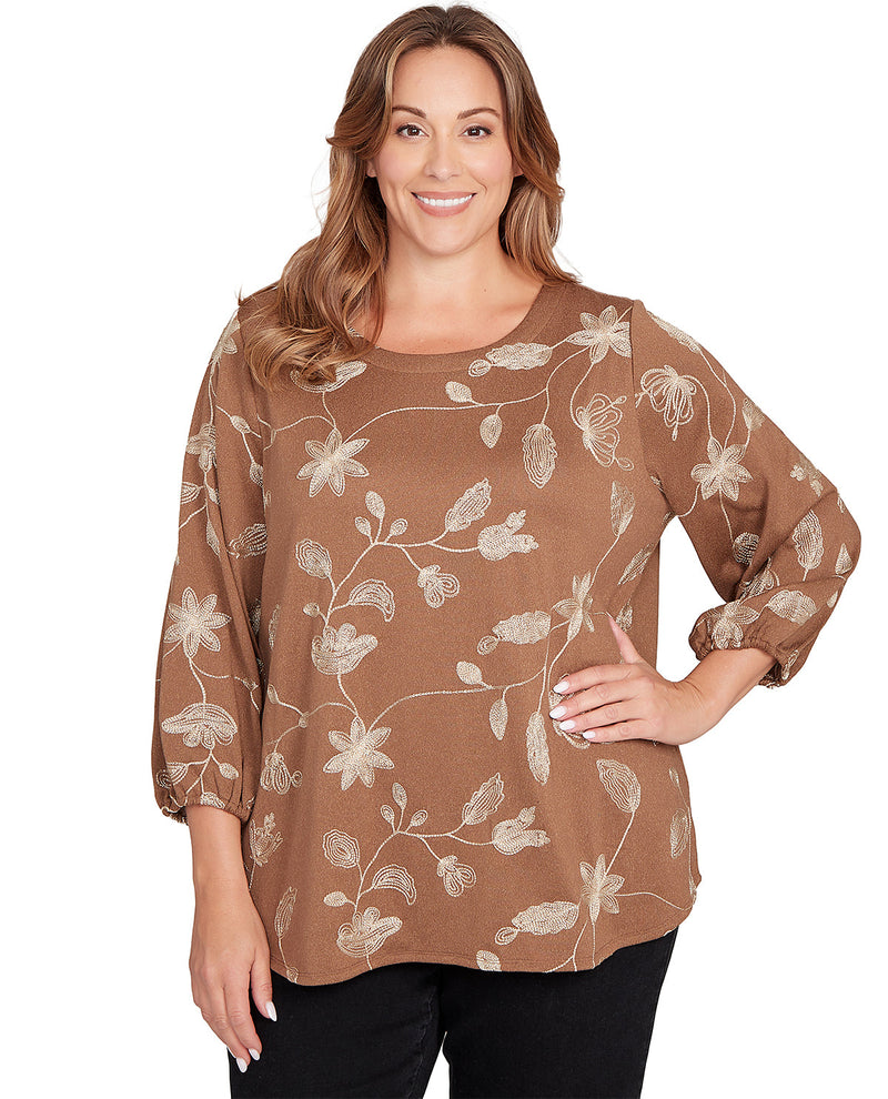 Woman wearing a brown floral blouse on a white background