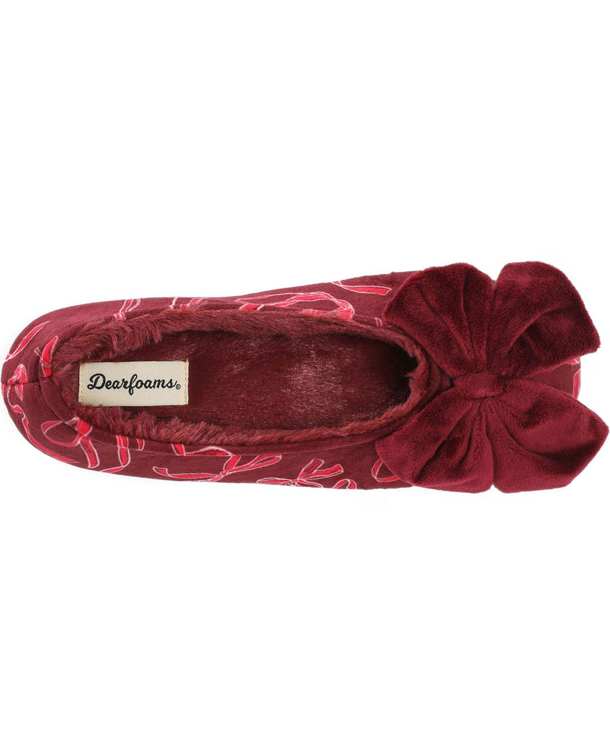A single red velvet slipper with a large bow on the toe and a pink floral pattern, shown from a top-down view on a white background. The brand label reads 'Dearfoams'.