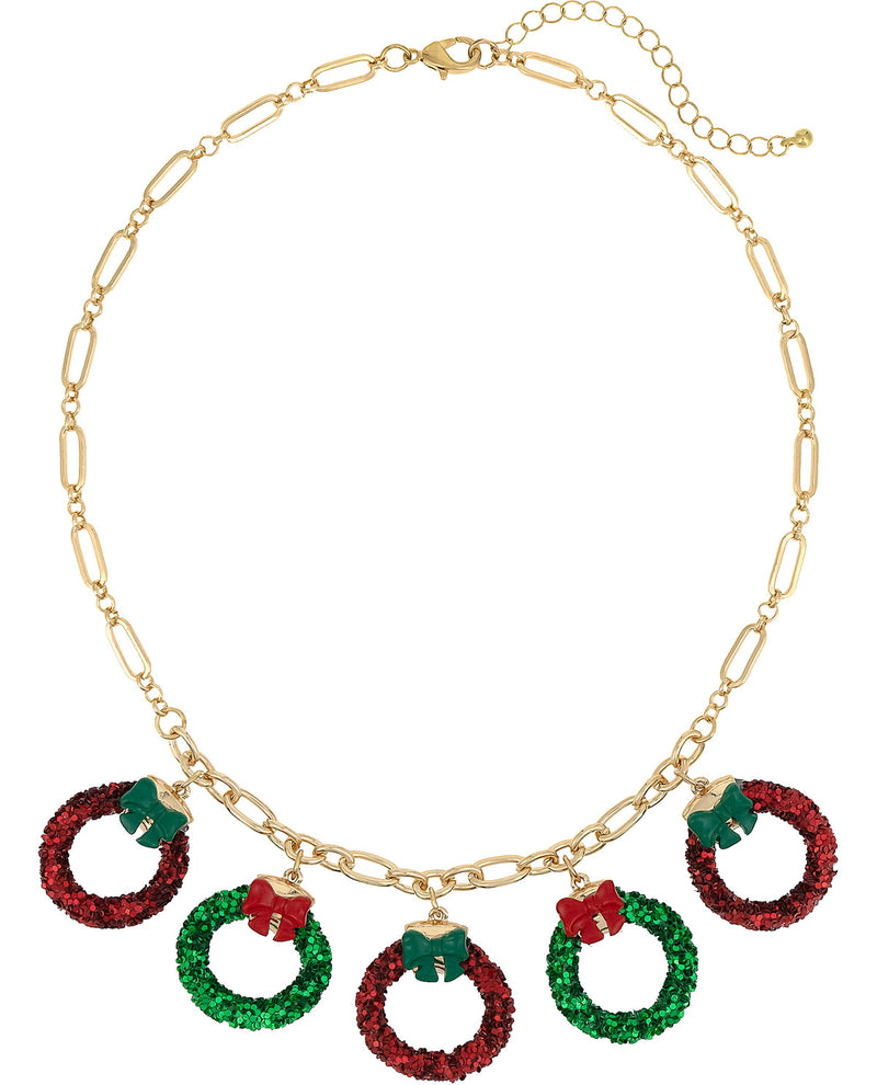 A gold-tone chain necklace featuring five holiday wreath charms in red and green rhinestones, each with a small red bow detail, displayed on a clean white background.