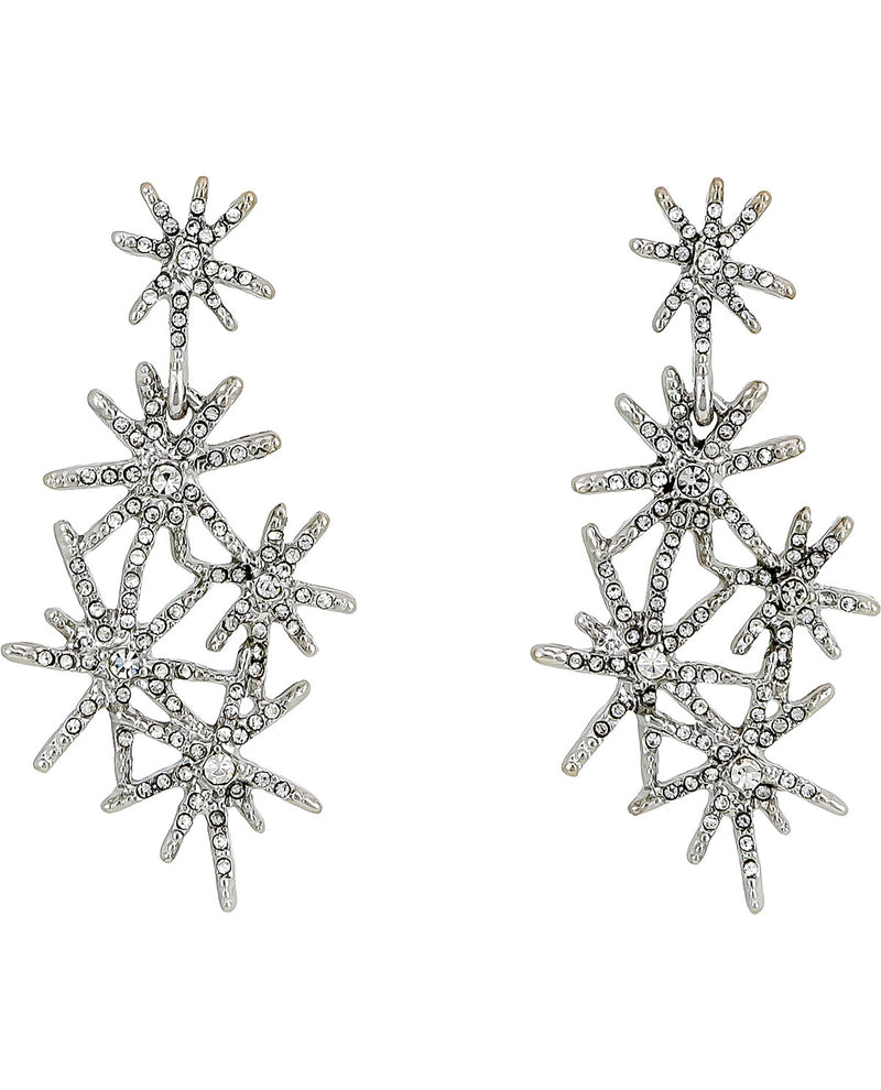 A pair of silver-toned dangle earrings featuring multiple overlapping starburst and snowflake-like clusters set with clear rhinestones, shown against a plain white background.