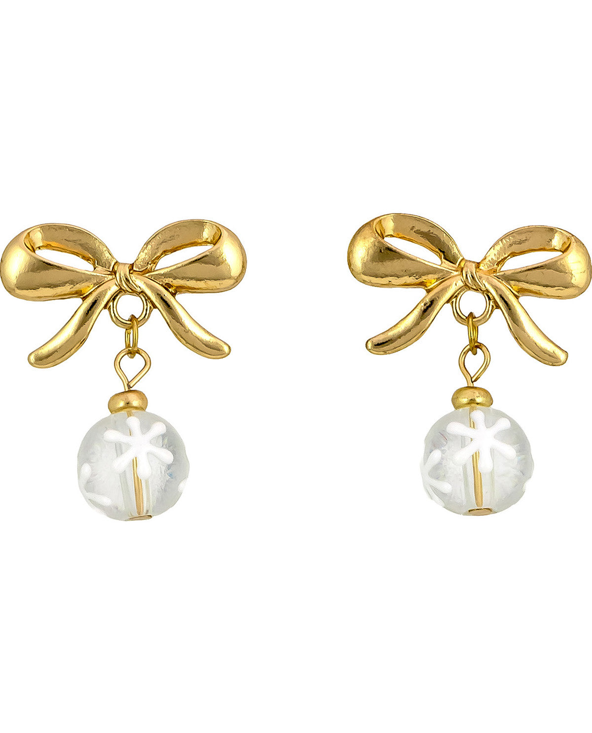 A pair of gold bow stud earrings with a dangling clear glass bead featuring a white snowflake design, set against a plain white background.