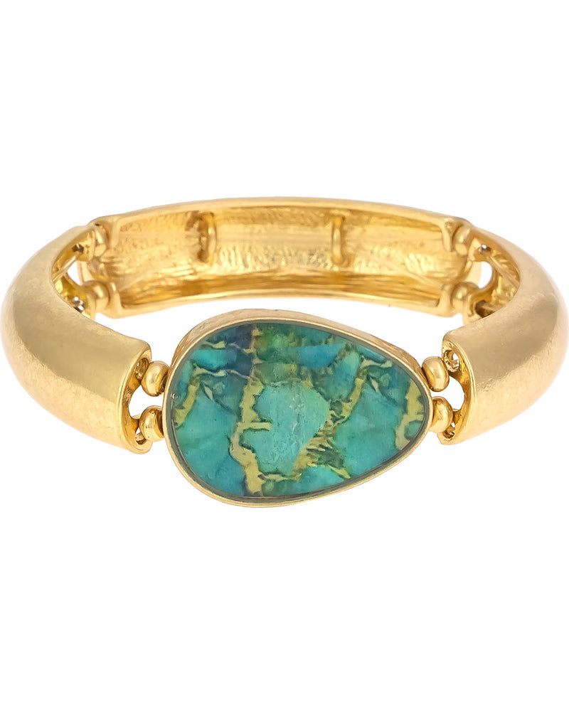 A gold-plated split-band ring featuring a large, teardrop-shaped turquoise stone with natural matrix patterns, set against a plain white background.