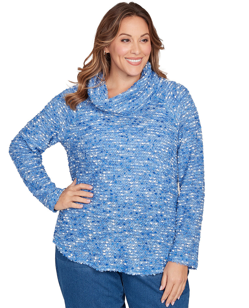 Woman wearing a blue textured sweater on a white background