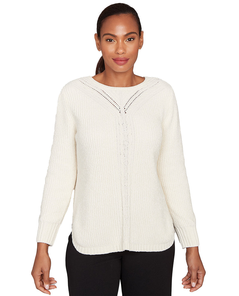 Woman wearing a cream-colored sweater with a subtle pattern on a white background