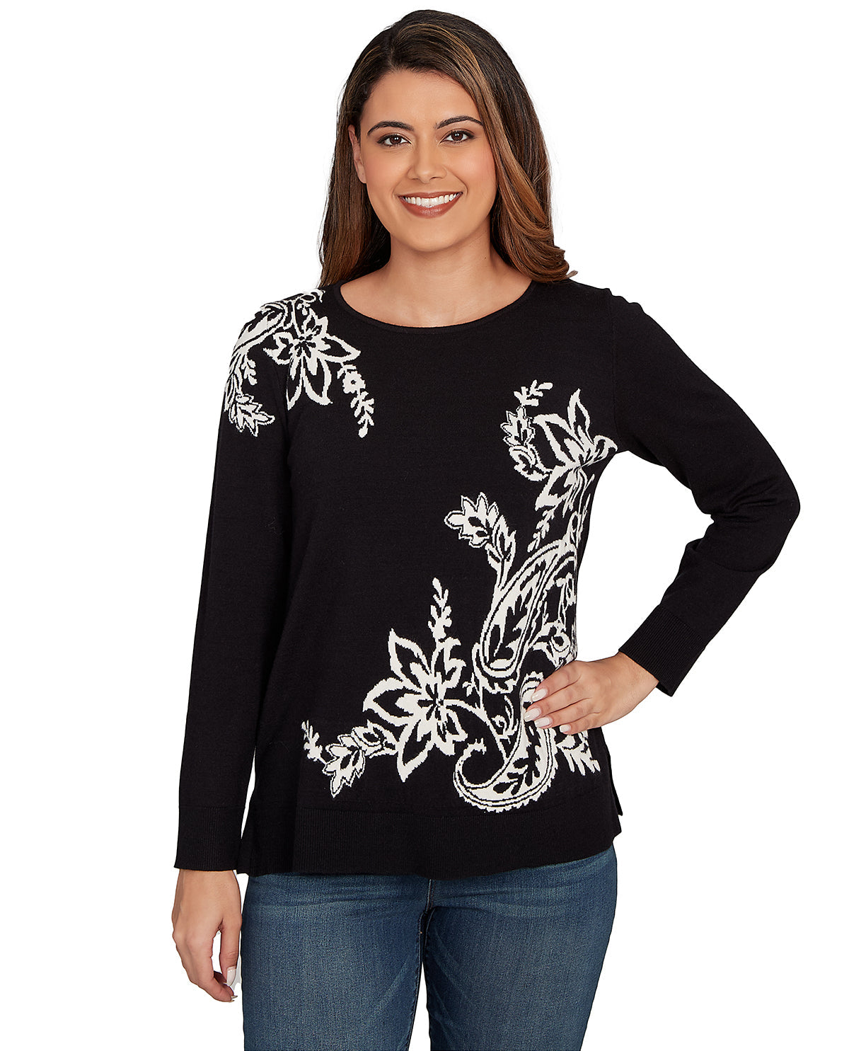 Woman wearing a black long-sleeve top with white floral patterns on a white background