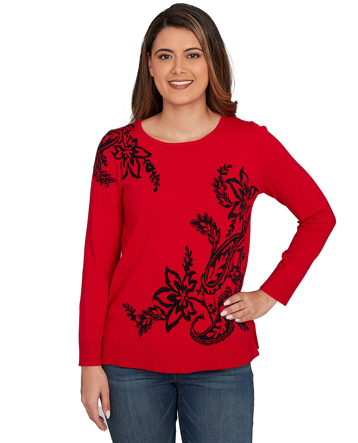 Woman wearing a red long-sleeve top with black floral patterns on a white background