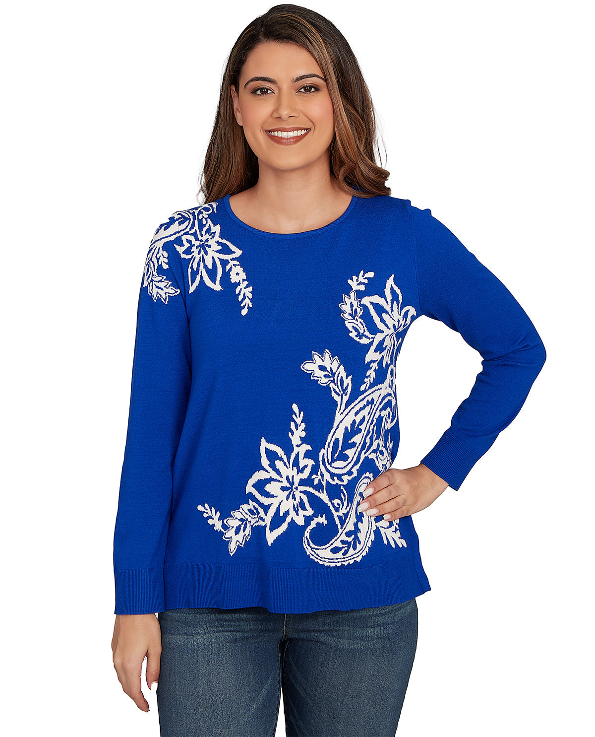 Woman wearing a blue long-sleeve top with white floral patterns on a white background