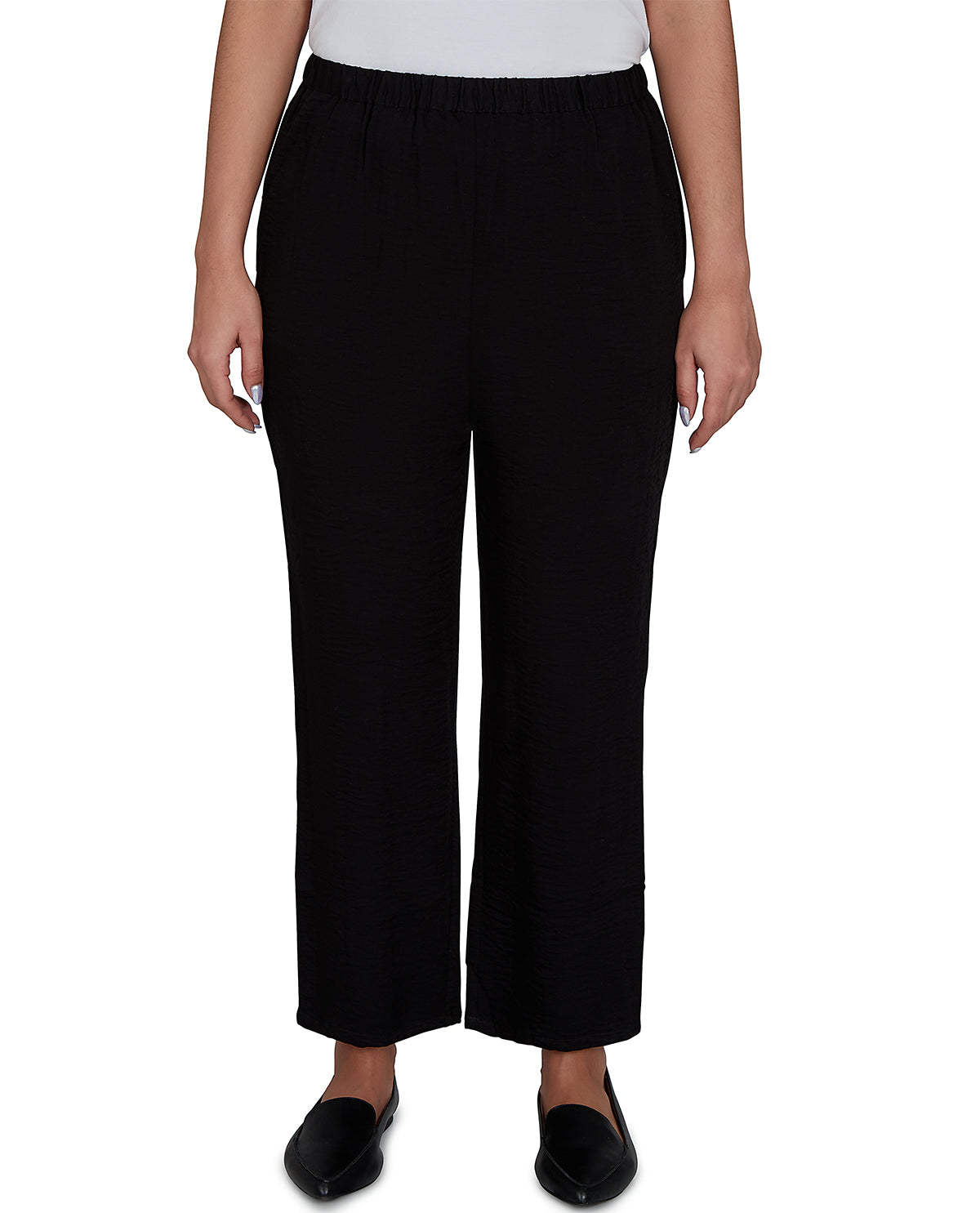 Person wearing black pants on a white background