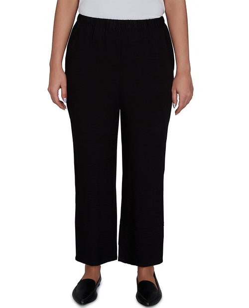 Person wearing black pants on a white background